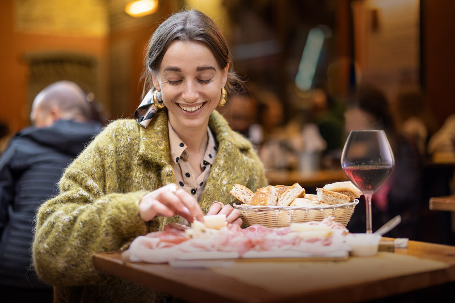 Ragazza mangia un tagliere di salumi tipici di Mantova